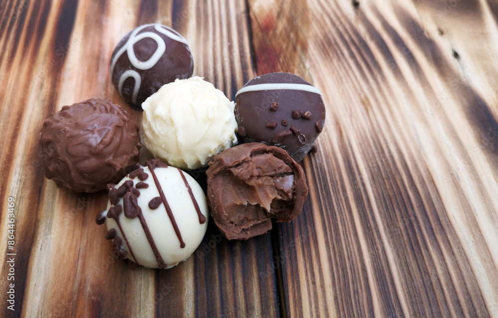 Chocolate truffles on wooden table Chocolate truffles on wooden table