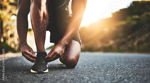 Foto Person, closeup and tying shoes with hands in street for running, morning workout or outdoor exercise