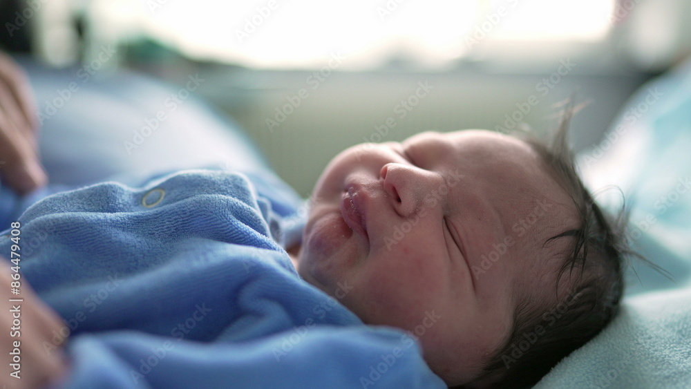 Newborn baby sleeping peacefully wearing blue onesie, close-up focus on the baby’s face. serene expression highlights the innocence and tranquility of a newborn’s restful sleep in early infancy Newborn baby sleeping peacefully wearing blue onesie, close-up focus on the baby’s face. serene expression highlights the innocence and tranquility of a newborn’s restful sleep in early infancy