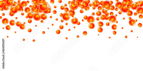 Vitamin E round capsules scattered randomly.
