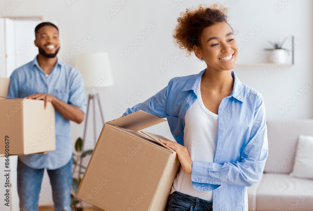 Moving New Home. Happy Black Spouses Carrying Packed Boxes Into Own Apartment. Selective Focus Moving New Home. Happy Black Spouses Carrying Packed Boxes Into Own Apartment. Selective Focus