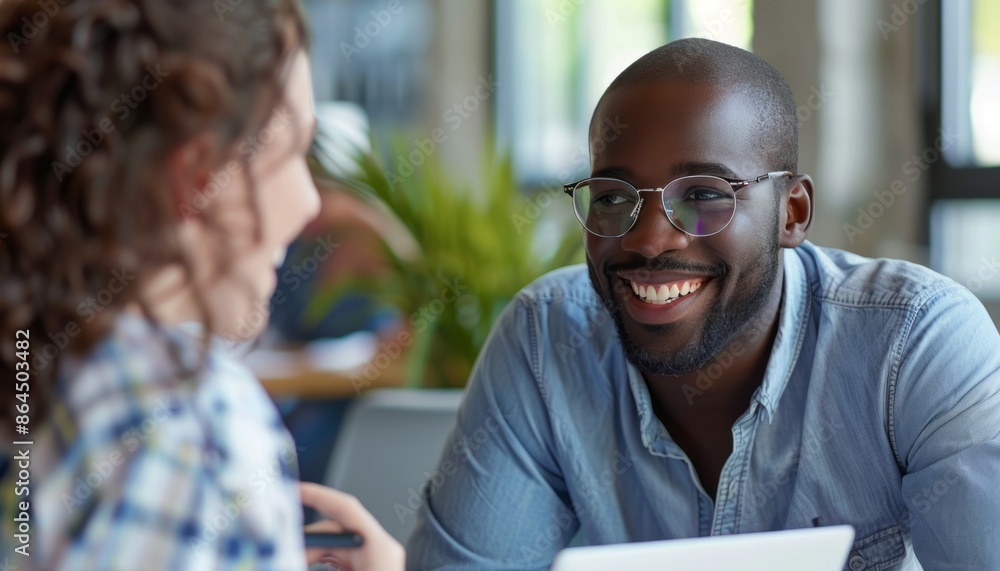 Smiling Man Wearing Glasses During a Meeting in an Office Smiling Man Wearing Glasses During a Meeting in an Office