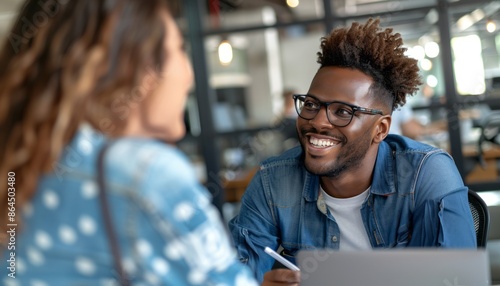 Man With Glasses Smiling at Woman in Modern Office