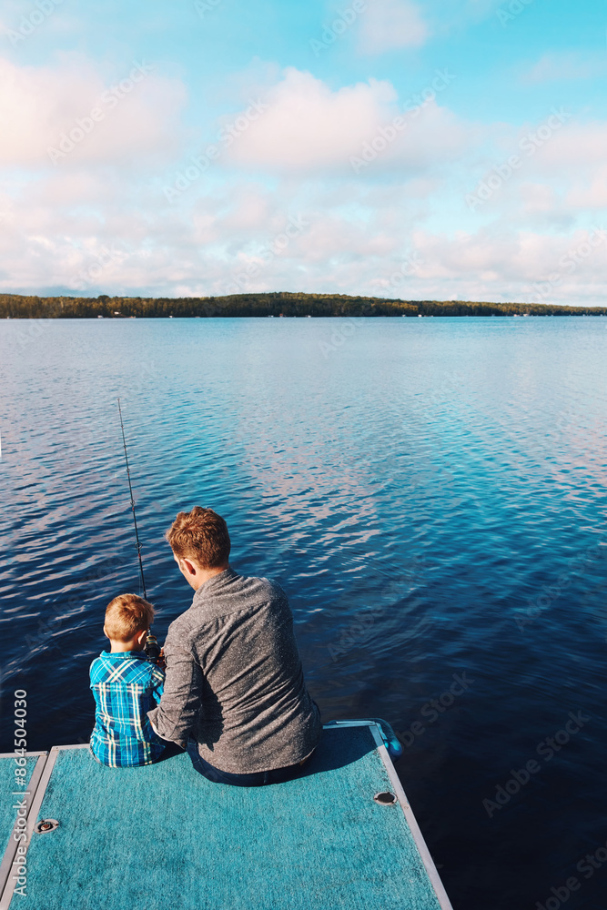 Fototapeta premium Fisherman, child and back at lake for fishing, together and relax for summer vacation. Family, father and son in nature by water for holiday, learning or gear for outdoor adventure with dad and kid