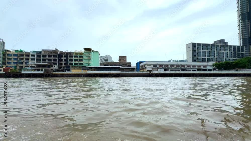 Chao Phraya River in BKK viewed from IconSiam Shopping Mall boats and ferries up and down the river and Bangkok high-rise buildings in the Background Chao Phraya River in BKK viewed from IconSiam Shopping Mall boats and ferries up and down the river and Bangkok high-rise buildings in the Background