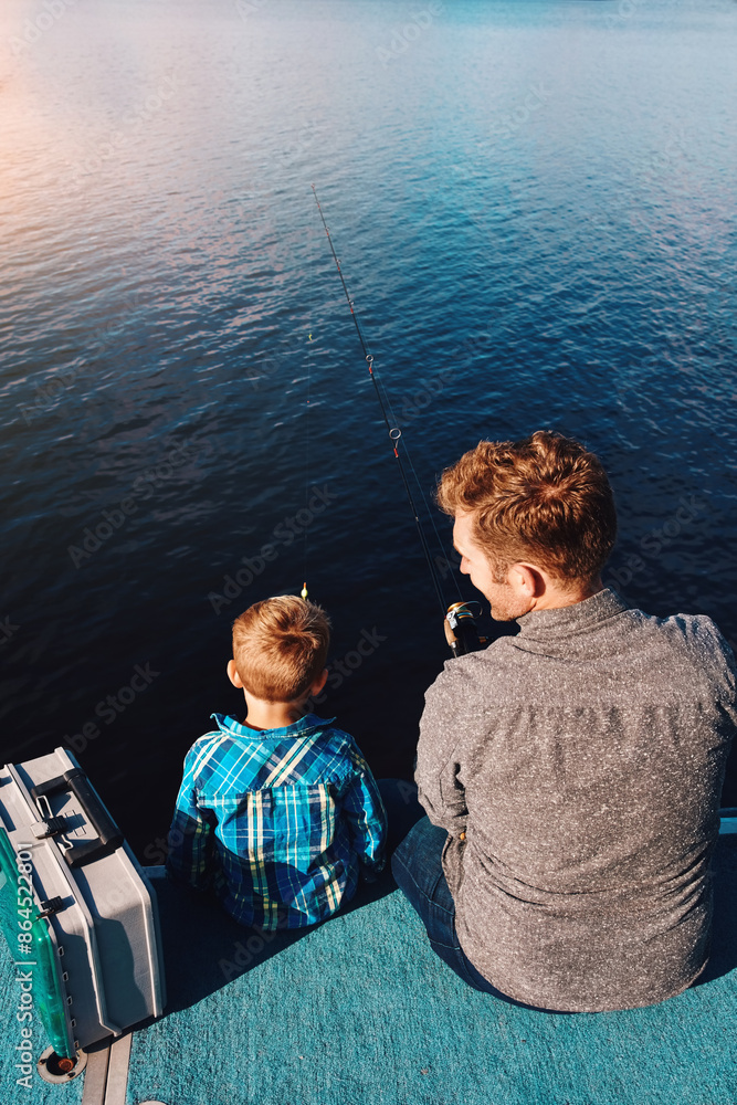 Fototapeta premium Above, child and father at lake for fishing, summer and vacation together in sunshine teaching. Family, fisherman and boy in nature by water for holiday, learning and outdoor adventure with dad