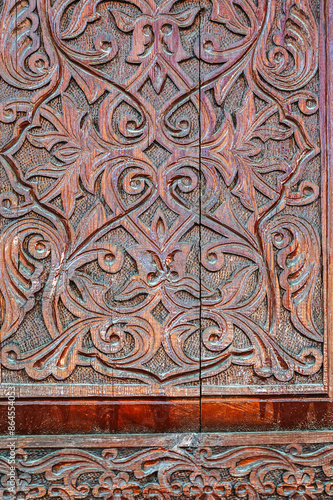 arabic Uzbek Islamic kandakori patterns arabesque ornament on an ancient wooden carved door in Uzbekistan close-up