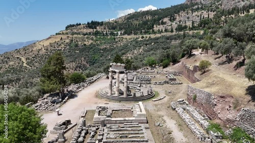 Aerial bird's eye view video taken by drone of archaeological site of ancient Delphi, site of temple of Apollo and the Oracle, Voiotia, Greece