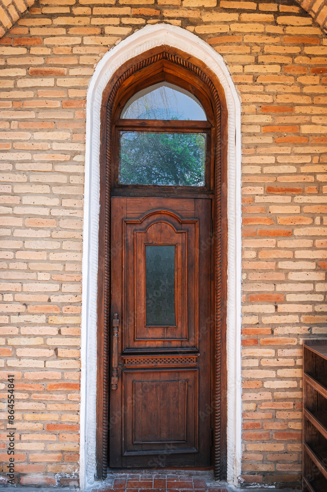 ancient carved wooden door to student room in Kukeldash madrasah with a traditional pattern ornaments in Uzbekistan in Tashkent ancient carved wooden door to student room in Kukeldash madrasah with a traditional pattern ornaments in Uzbekistan in Tashkent