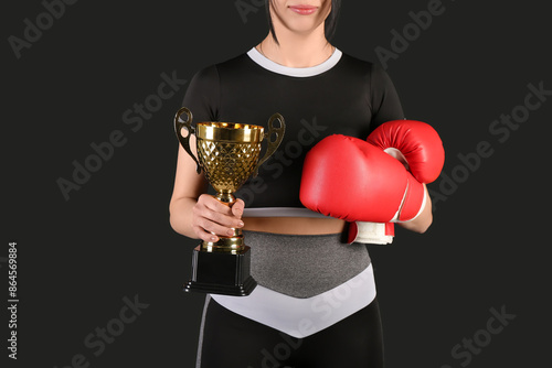 Female boxer with gold cup ...