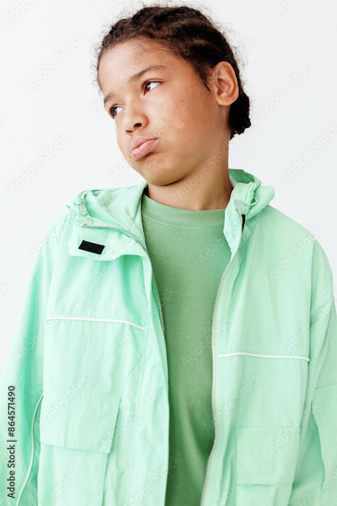 Fashionforward young boy in green jacket and tshirt exudes trendy style against clean white backdrop Fashionforward young boy in green jacket and tshirt exudes trendy style against clean white backdrop