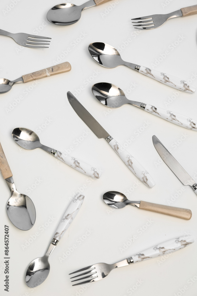 Set of stainless steel cutlery with plastic handles on white background Set of stainless steel cutlery with plastic handles on white background