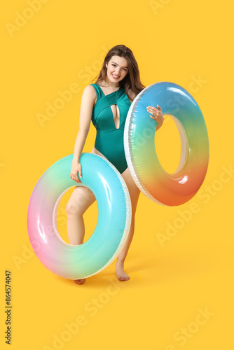 Young woman with swim rings...
