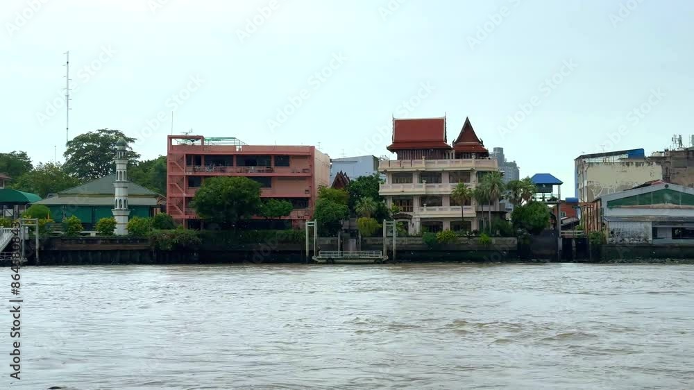 Chao Phraya River in BKK viewed from IconSiam Shopping Mall boats and ferries up and down the river and Bangkok high-rise buildings in the Background Chao Phraya River in BKK viewed from IconSiam Shopping Mall boats and ferries up and down the river and Bangkok high-rise buildings in the Background