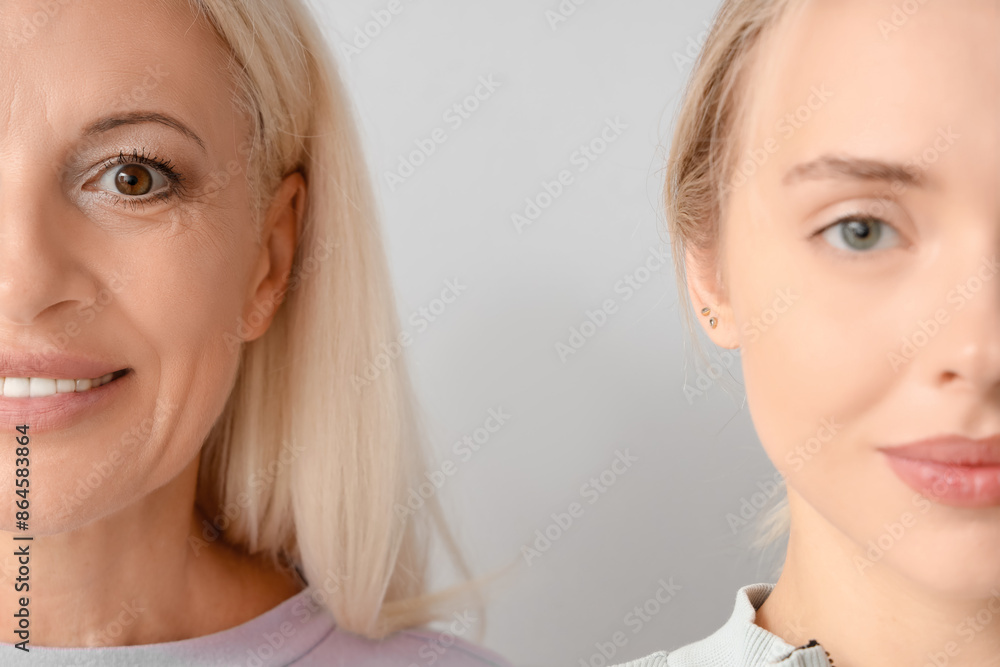 Happy young beautiful woman with her mother on grey background Happy young beautiful woman with her mother on grey background