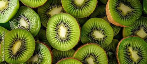 A top view of fresh ripe kiwifruits with radial shape, bright green flesh, edible black seeds, sweet taste, and copy space image available. photo