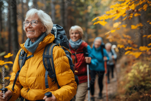 Senior hikers in autumn forest. Elderly women enjoying outdoor activity and exercise in a beautiful fall setting. Ideal for promoting active lifestyles and senior well-being in travel
