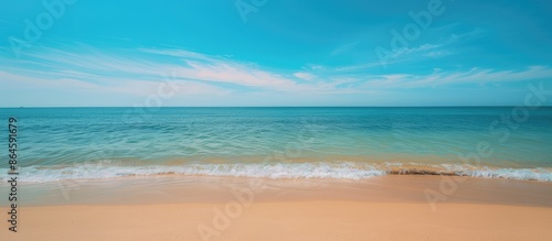 A relaxing summer scene with a tranquil beach, clear blue sky, and a calming ocean view, perfect as a copy space image.