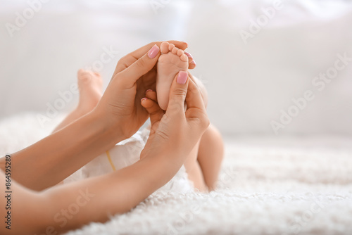 Mother massaging her baby's...