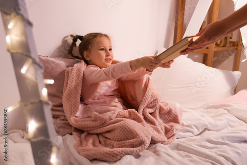 Cute little girl taking boo...