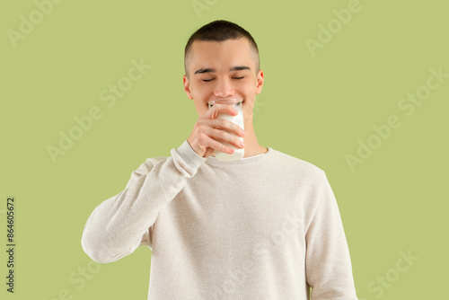 Teenage boy drinking milk o...