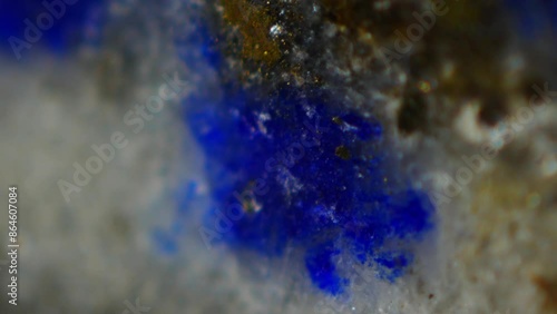 Lapis Lazuli under microscope: (Na,Ca)8(AlSiO4)6(SO4,S,Cl)2, deep blue with gold flecks, prized since ancient times. Mohs hardness 5-6. Contains lazurite, calcite, pyrite. Valued for beauty, spiritual