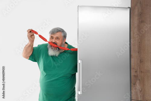 Mature man with tasty sausa...