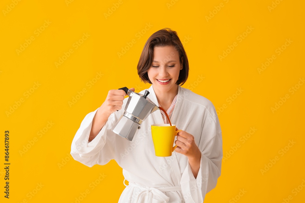 Beautiful young happy woman in bathrobe with cezve and cup of coffee on yellow background Beautiful young happy woman in bathrobe with cezve and cup of coffee on yellow background