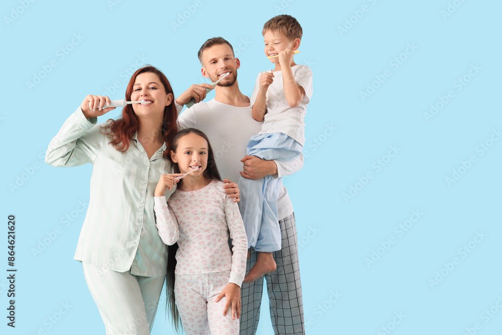 Happy family brushing teeth on blue background Happy family brushing teeth on blue background