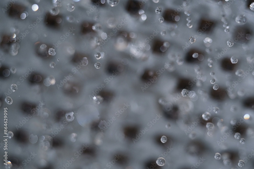 Macro shot of water droplet flowing from head shower Macro shot of water droplet flowing from head shower