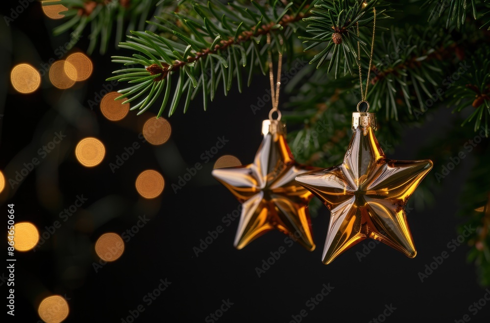 golden christmas ornaments hanging on pine tree with bokeh lights golden christmas ornaments hanging on pine tree with bokeh lights