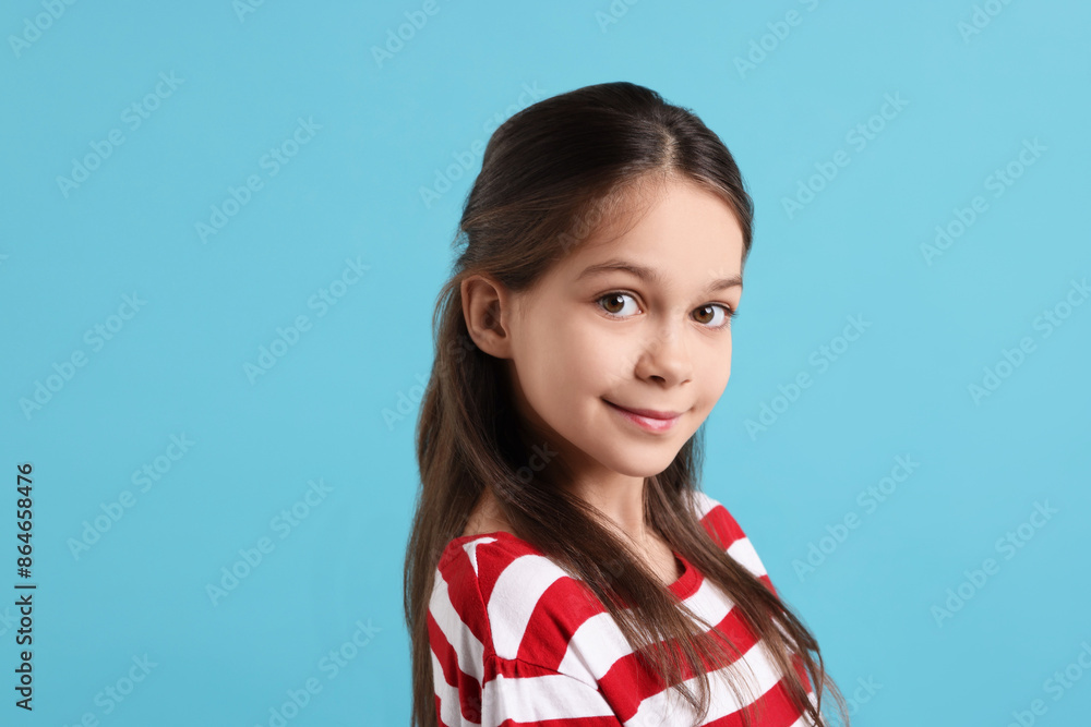 Portrait of beautiful girl on light blue background Portrait of beautiful girl on light blue background