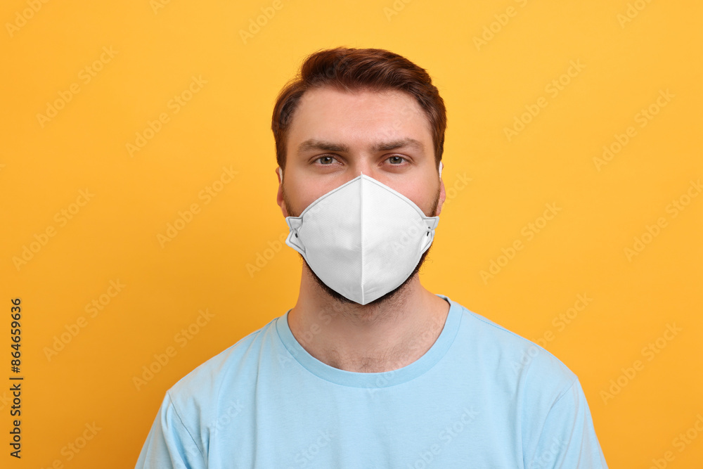 Man in respirator mask on yellow background Man in respirator mask on yellow background