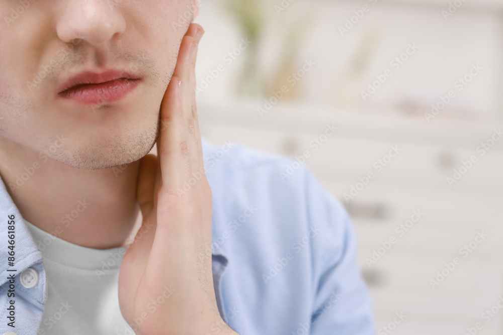 Man suffering from toothache at home, closeup. Space for text Man suffering from toothache at home, closeup. Space for text