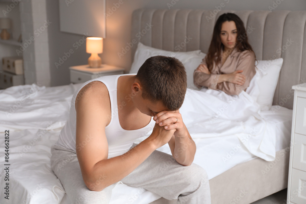 Fototapeta premium Offended couple after quarrel in bedroom. Relationship problem
