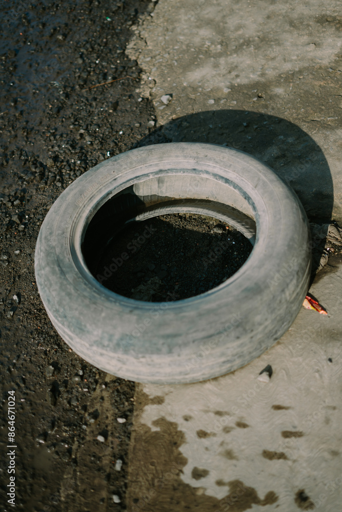 Old, used tire, showcasing signs of wear and tear, ideal for recycling or upcycling projects Old, used tire, showcasing signs of wear and tear, ideal for recycling or upcycling projects