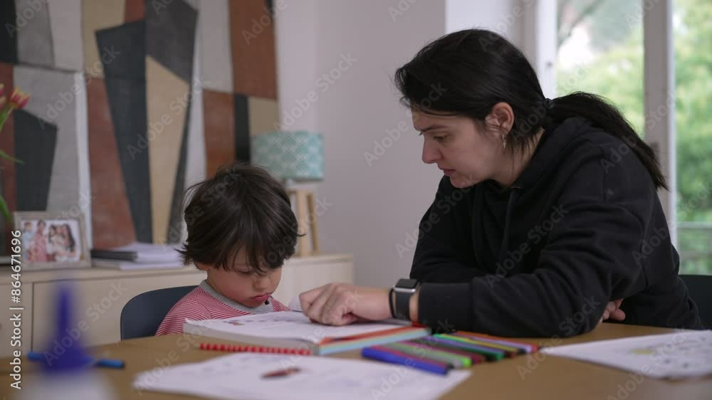 Mother guiding young child who feels reluctant and frustrated with homework, surrounded by educational tools and colorful pencils, demonstrating supportive home learning environment Mother guiding young child who feels reluctant and frustrated with homework, surrounded by educational tools and colorful pencils, demonstrating supportive home learning environment