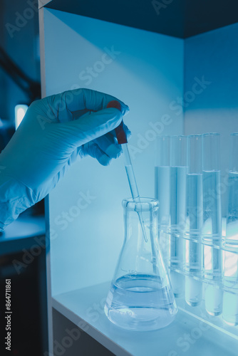 a scientist is working in a laboratory, a chemical researcher is preparing sample for a vaccine against a virus, work in lab concentrate is the most important because chemicals are dangerous photo