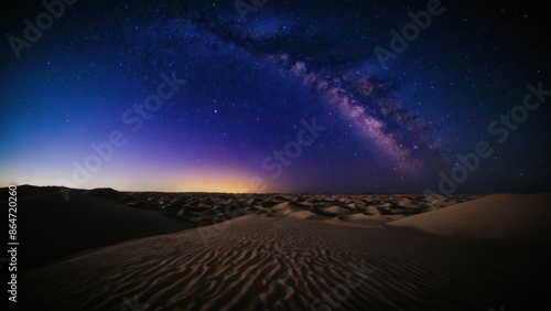 a photograph of the night sky is filled with stars and the desert is lit up by the light of the milky