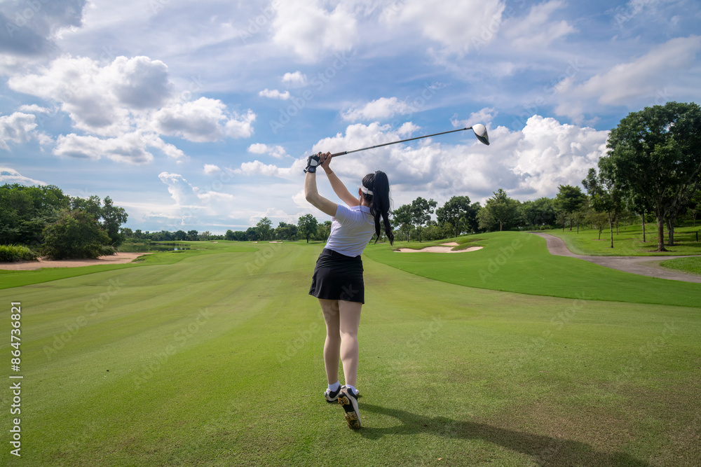 Fototapeta premium Professional woman golfer teeing golf in golf tournament competition at golf course for winner 