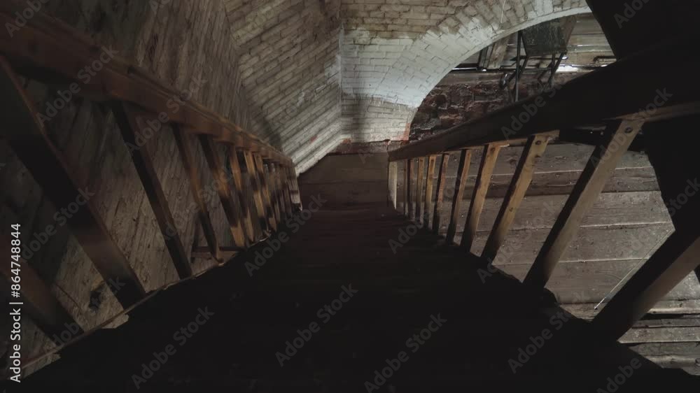 An ancient wooden staircase leading to the attic of an old historical building. An atmosphere of exploration and mystery. An ancient wooden staircase leading to the attic of an old historical building. An atmosphere of exploration and mystery.