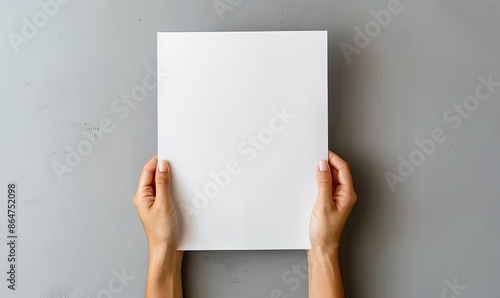 Woman's Hands Holding Blank White Paper Against Grey Background