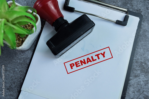 Photos Red Handle Rubber Stamper and Penalty text above paperwork isolated on wooden ba