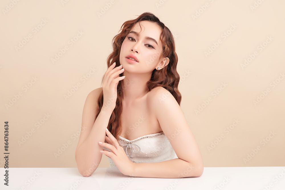 Naklejka premium Beautiful young asian woman with clean fresh skin on beige background, Face care, Facial treatment, Cosmetology, beauty and spa, Asian women portrait.