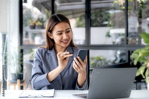 Successful businesswoman financier investors use smartphone to communicate remotely over the internet or video call to set challenging business goals and ready to achieve targets from work office