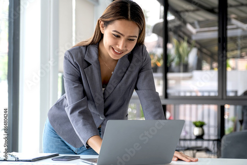 Businesswomen bookkeeper use laptop analysis the graph for Setting challenging business goals and ready to achieve target at home office