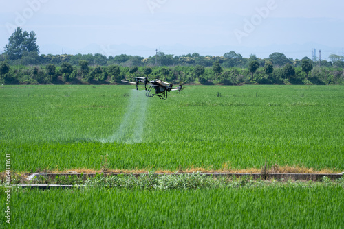 agricultural drone spraying pesticide in field photo