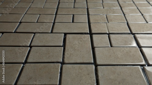 Close-Up of Glossy Beige Tiles with Subtle Patterns and Varied Sizes on Floor