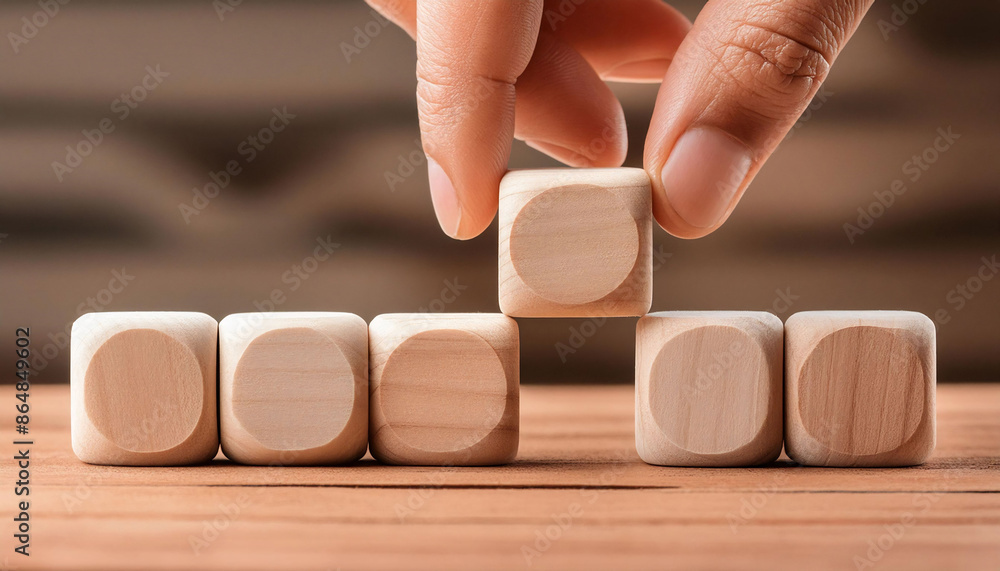 closeup hand stacking a wooden block on table, strategy, balance, teamwork concept. closeup hand stacking a wooden block on table, strategy, balance, teamwork concept.