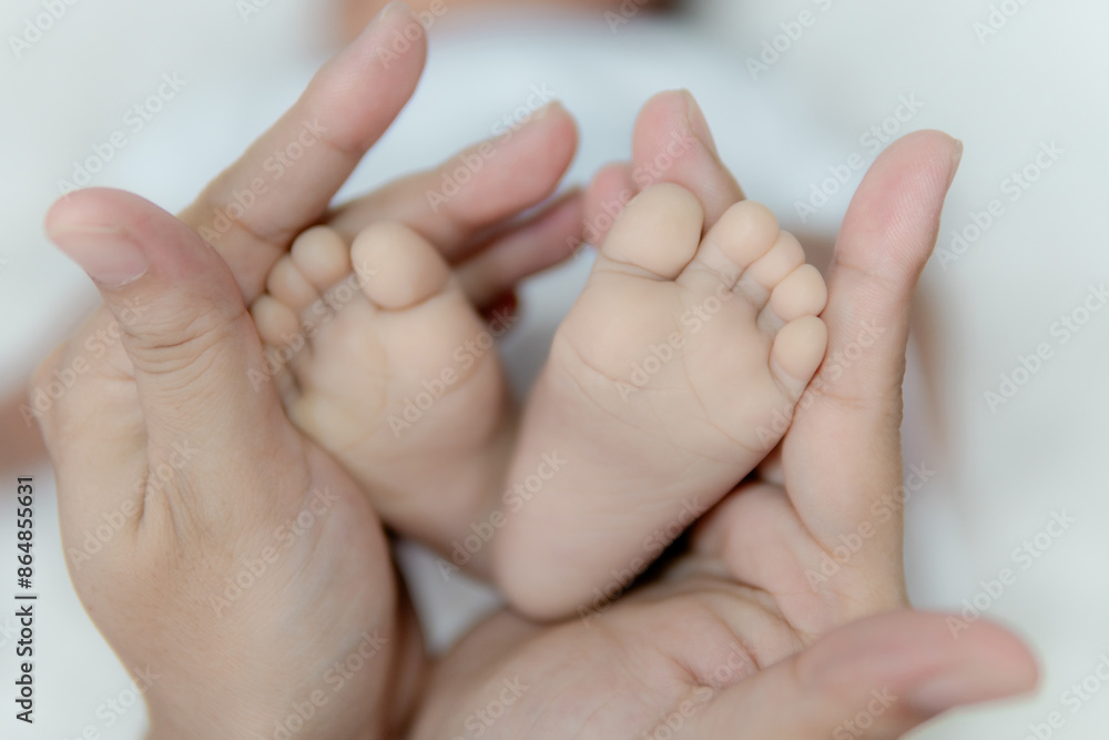 Parent holding in the hands feet of newborn baby. Parent holding in the hands feet of newborn baby.